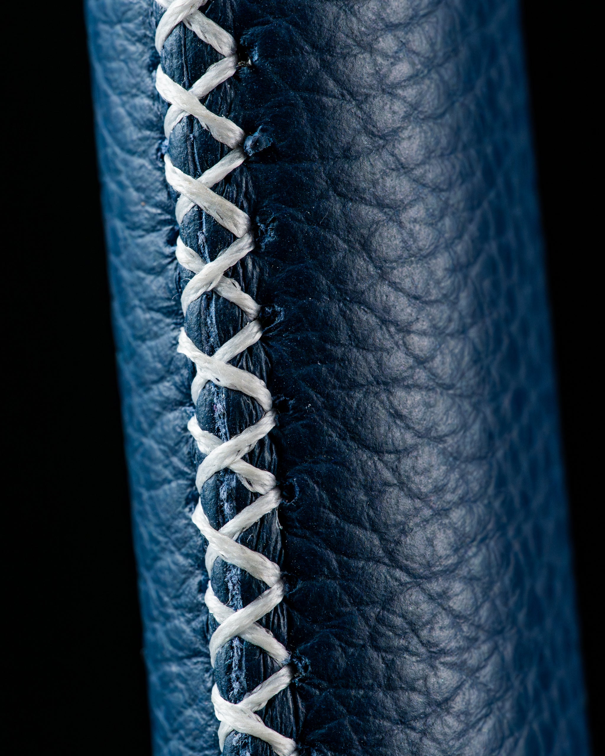 Close-up of the Edel Twister Putter grip showcasing detailed stitching and textured leather in a deep blue color.