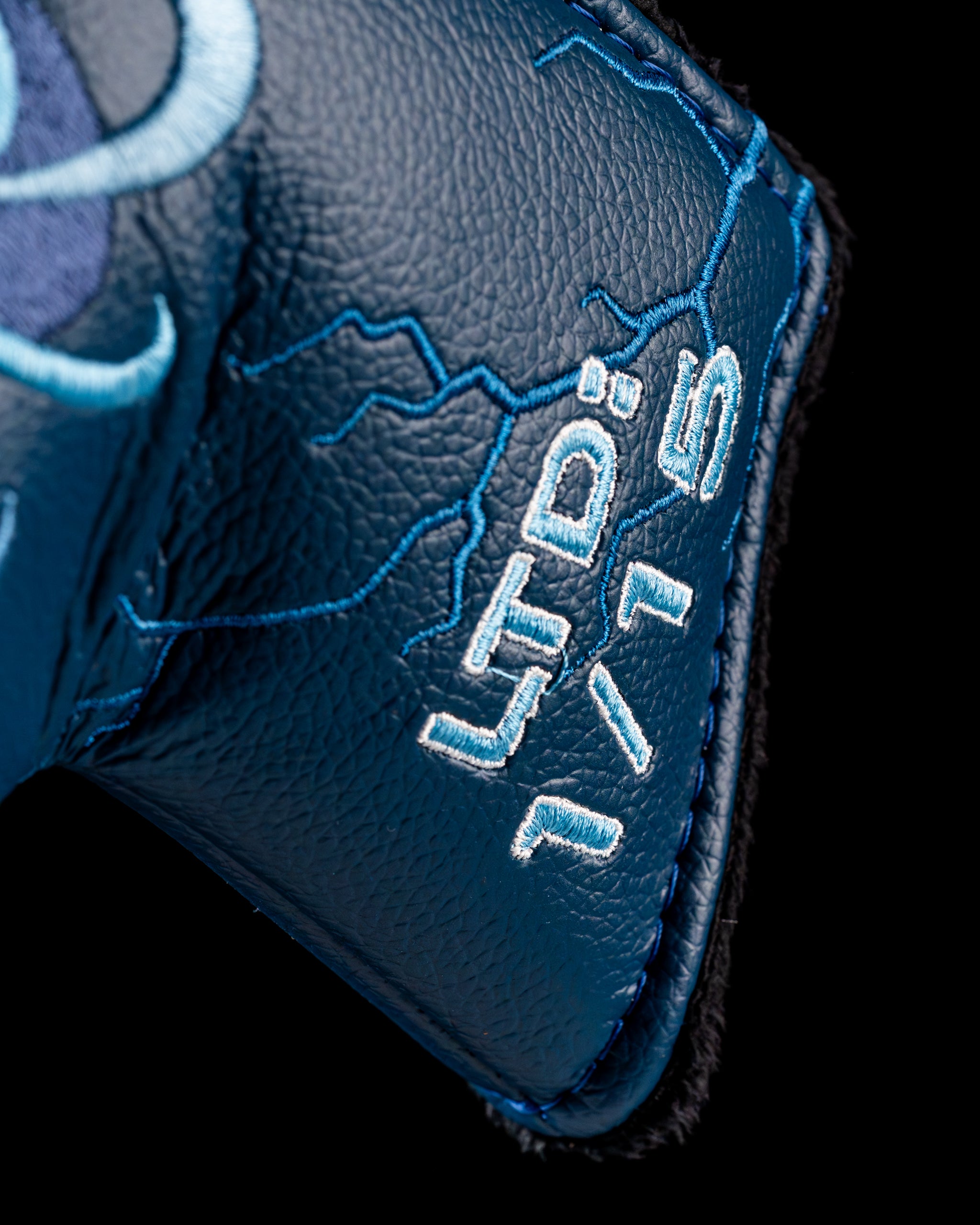 Close-up of the Edel Twister Putter grip, featuring a textured blue leather design with intricate stitching details.