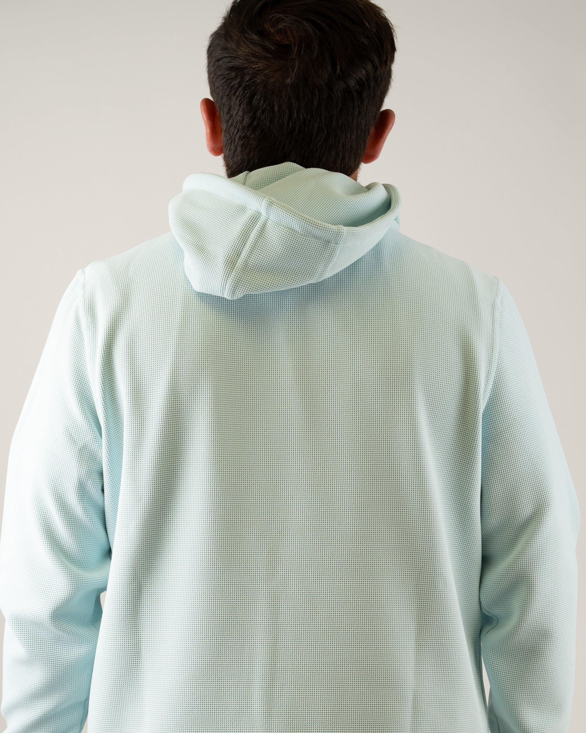 Ice blue waffle grid hoodie with a relaxed fit and adjustable hood, designed for comfort on and off the golf course.