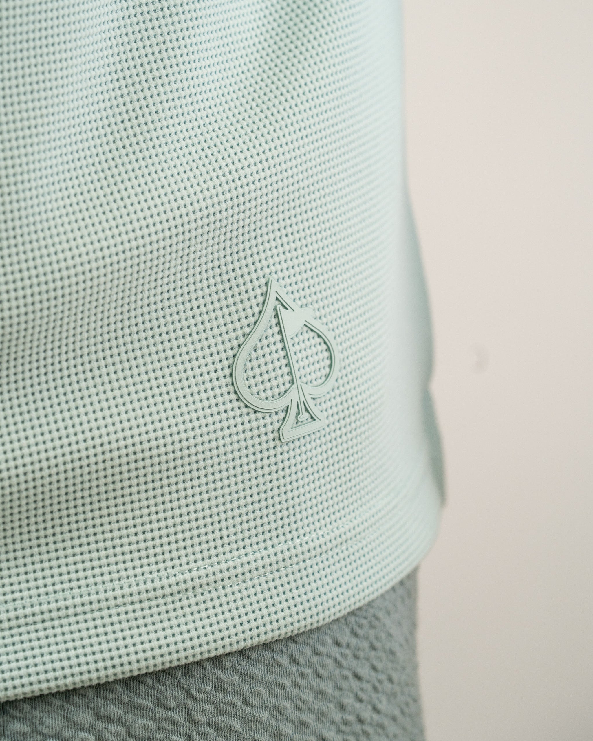 Ice blue waffle grid hoodie featuring a subtle spade logo, perfect for stylish comfort on the golf course.