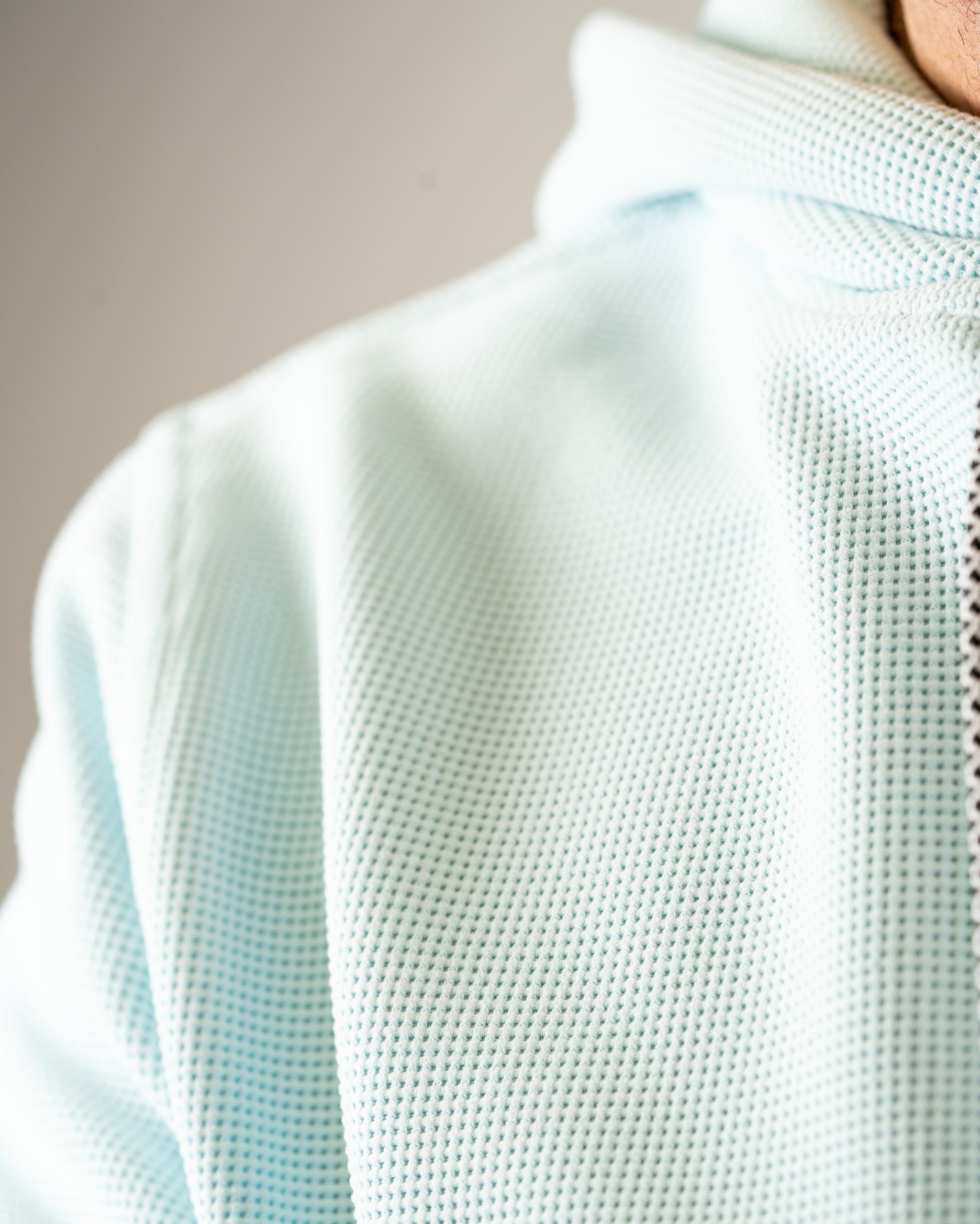 Ice blue waffle grid hoodie featuring a textured fabric, designed for comfort and style on the golf course.